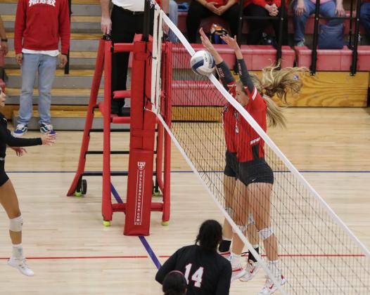 Junior Payton Murray and sophomore Sydney Linn go up for a block in the first set of their regional semifinal match with Brownfield on Tuesday, Nov. 10, in Tuscola.