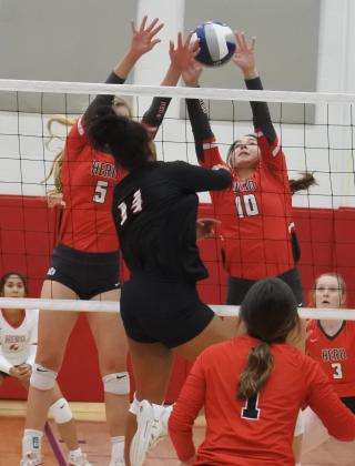 Senior Bree Zellers and junior Payton Murray reject a shot in the first set of their regional semifinal match with Brownfield on Tuesday, Nov. 10, in Tuscola.