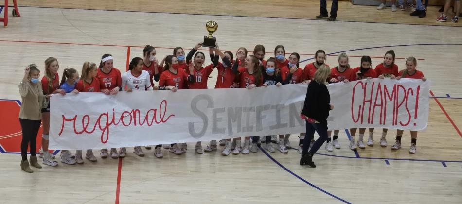 Holliday celebrates with the regional semifinals championship trophy and banner following Holliday’s 3-0 win over Brownfield on Tuesday, Nov. 10, in Tuscola.