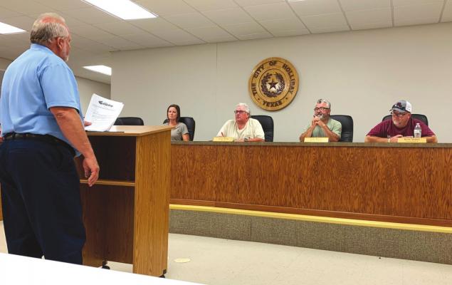 An ONCOR Electric Delivery Company representative presents the proposed rate increase from the company to the Holliday City Council on Monday, June 13. Photo/Nathan Lawson