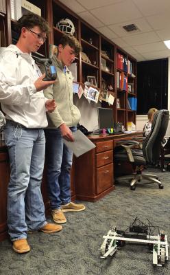 Grayson Steinberger (right) and Landon McLemore (left) shoow off the Windthorst robotics program project Troy Blue as part of school board recognition month in the Windthorst ISD board meeting on Monday, Jan. 23. Photo/Nathan Lawson