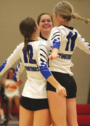Windthorst’s Bree Kirk, Rylee Wolf and Annikah Frank get fired up to play before the first serve in the Trojanettes’ 3-1 win over Christ Academy on Saturday, Sept. 11. Photo/Will Edwards