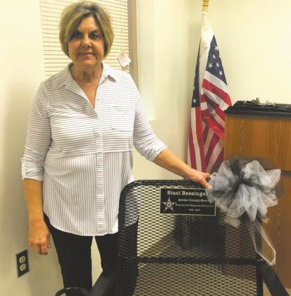 Archer County Sheriff Staci Williams Beesinger poses with a chair she was gifted at her retirement party Dec. 17. Beesinger's last day on the job is Thursday, Dec. 31, before Jack Curd takes over. Courtesy photo/P.A. Veith