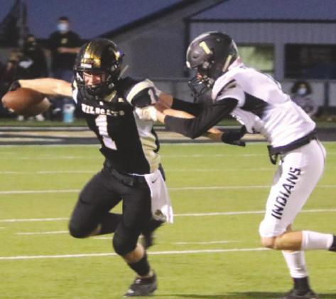 Senior Callen McCasland attempts to break free from a Quanah defender in the first quarter of Archer City’s 38-20 loss to the Indians on Friday, Oct. 2. Photo/Jerry Phillips