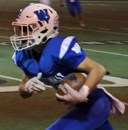 Windthorst senior Max Owen races down the sideline for the game’s only touchdown as the Trojans knocked off Wellington, 7-0, to advance to the State Championship game.