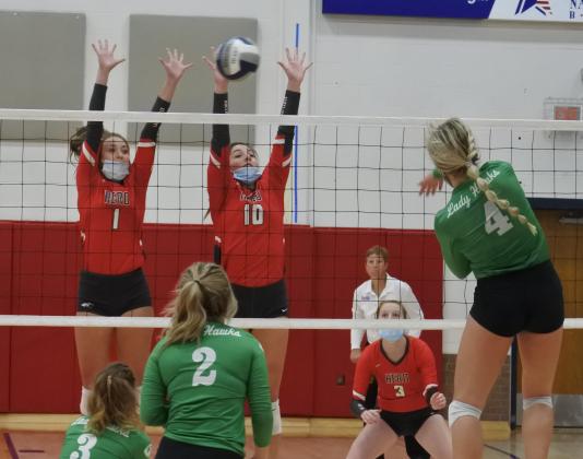 Seniors Brittany James (1) and Bree Zellers (10) go up for a block in the first set of Holliday’s 3-1 win over Wall in the Region I-3A area round on Tuesday, Nov. 3, in Tuscola.