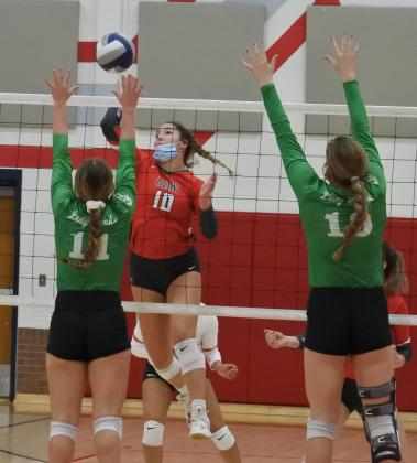 Senior Bree Zellers swings over a pair of Lady Hawk defenders in the first set of Holliday’s 3-1 win over Wall in the Region I-3A area round on Tuesday, Nov. 3, in Tuscola.