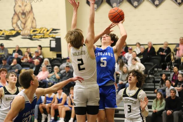 Windthorst's Brayden Berend attempts a layup over Archer City's Layken Cagle