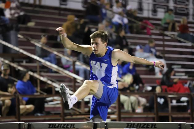 Carson Anderle leaps over a hurdle