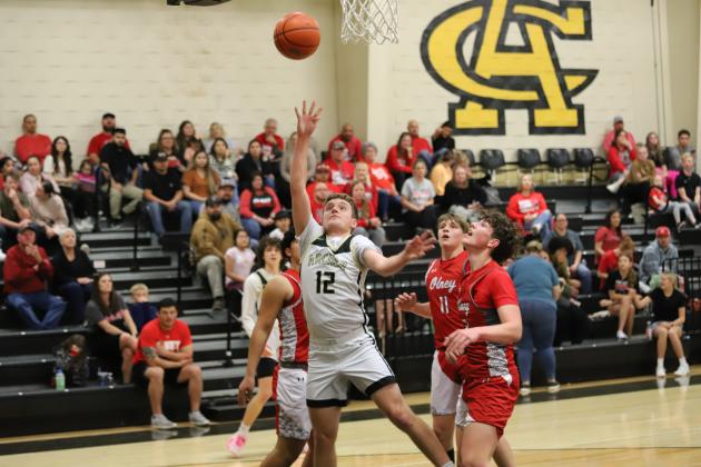 Archer City's Chase Curry puts in a tough layup 