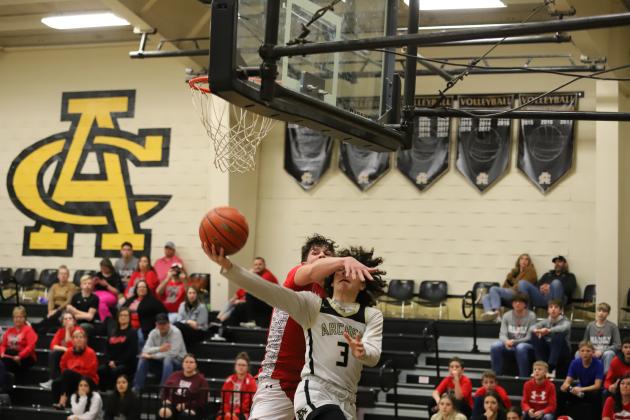 Archer City's Haegen Deerinwater gets fouled while attempting a reverse layup 