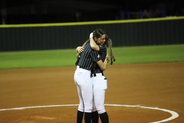 Malia Jones and Nicole Crouse embrace