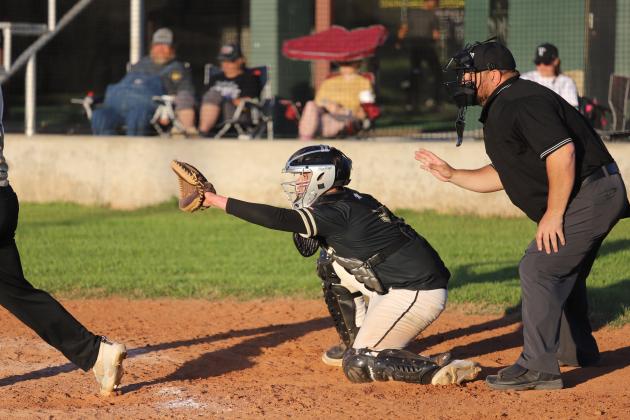 Johnathan Clay sits behind the plate