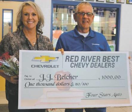 J.J. Belcher is presented the award as Red River Best Chevy Dealer Teacher of the Year by Gene Klinkerman of FourStars Auto Ranch.