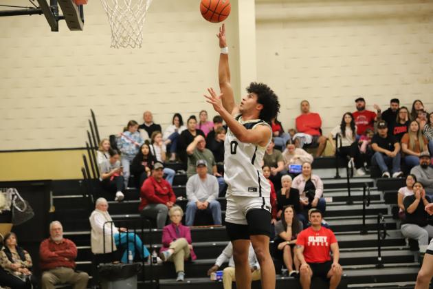 Archer City's Kole Stovall attempts a shot in front of the rim