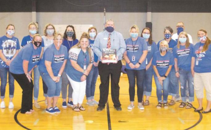Windthorst Elementary School Faculty poses with Blue Bell representative Floyd Moore (center) as he gifts a book on the company’s history. Photo/Nathan Lawson