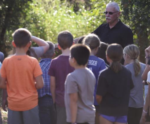 Windthorst fourth graders listen to ACMAC Treasurer Brad Mitchell give a history of Stonewall Jackson Camp and the Comanche Tree Marker on Wednesday, Oct. 1 Photo/Landon Davis