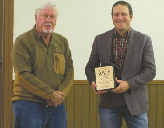 Archer SWCD Director Glenn Thorman (left) presents Adam Wolf (right) with the organization's Producer of the Year award. Photo/Nathan Lawson