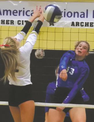 Windthorst sophomore Tara Tackett tries to get the ball past Archer City junior Mallory Maxwell in the second set of Archer City’s 3-2 win over the Trojanettes on Tuesday, Oct. 13, in Archer City. Photo/Will Edwards