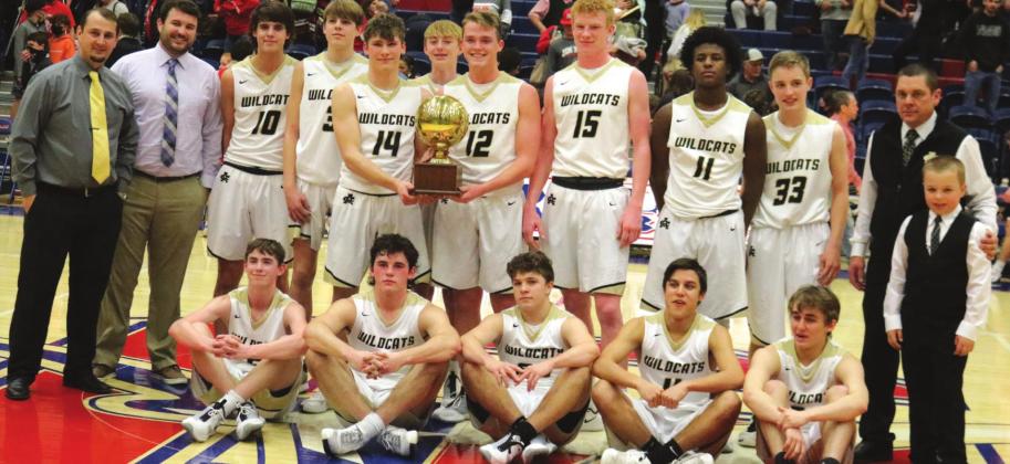 Archer City poses with the bi-district championship trophy following its 68-52 win over Anson on Saturday, Feb. 20, in Graham. Photo/Jerry Phillips