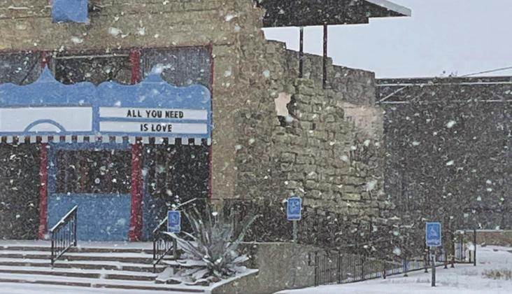 Snow falls at the Royal Theater in Archer City on Sunday, Feb. 14. The county and state experienced record low temperatures and six to eight inches of snow over the weekend. Photo/Jerry Phillips