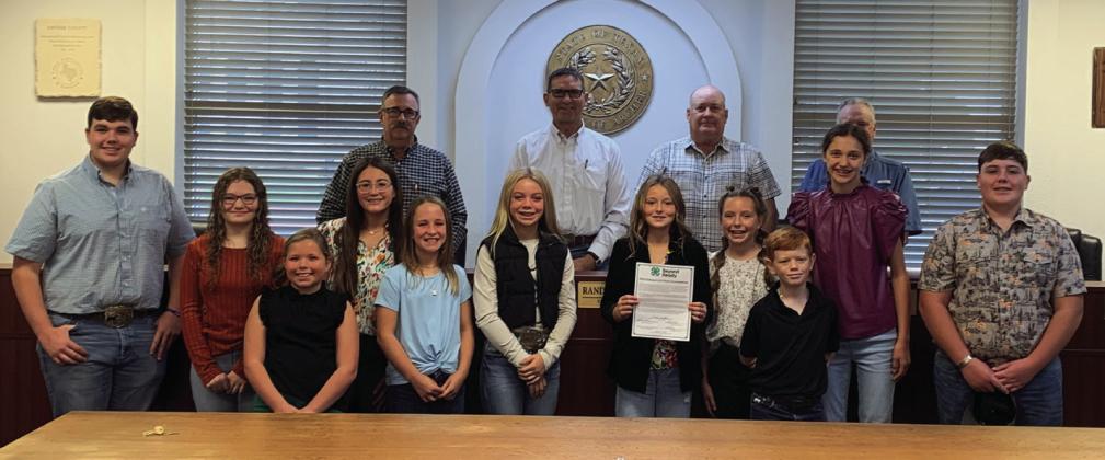 Members of Archer County 4-H pose for a photo with the commissioner's court following the declaration of 4-H week. Photo/Nathan Lawson