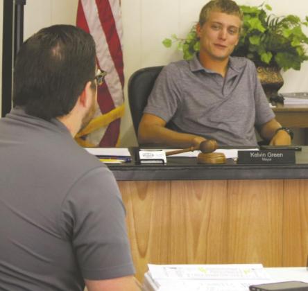 Archer City Mayor Kelvin Green (right) speaks to city council member Ben Tucker during the Archer City city council meeting Thursday, Sept. 3. Photo/Jerry Phillips