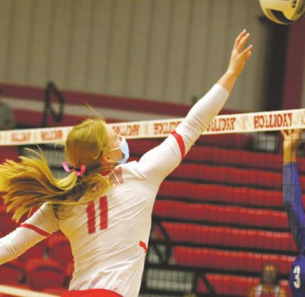 Holliday sophomore Campbell Jurecek swings over a pair of City View defenders in the Lady Eagles’ 3-0 sweep of the Mustangs on Tuesday, Oct. 13. Courtesy photo/Jolene Styles