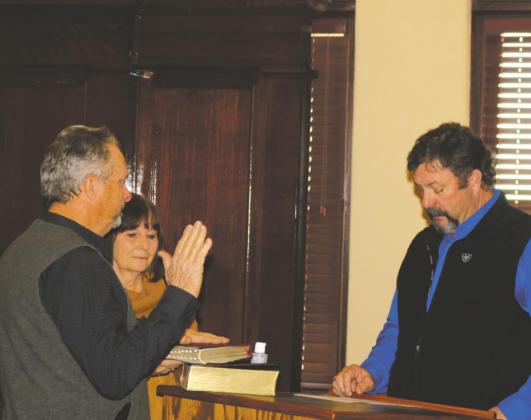 Wade Scarbrough is sworn in as County Commissioner Pct. 1 by his brother Corky, Justice of the Peace Pct. 2, during the swear-in ceremony on Monday, Jan. 4. Photo/Jerry Phillips