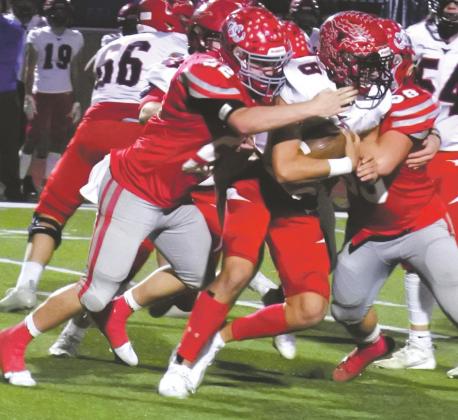 The Eagles defense swarms Eastland quarterback Behren Morton in the third quarter of Holliday’s 28-24 loss to the Mavericks in the 3A-DII regional semifinals on Friday, Nov. 27, in Graham. Photo/Will Edwards