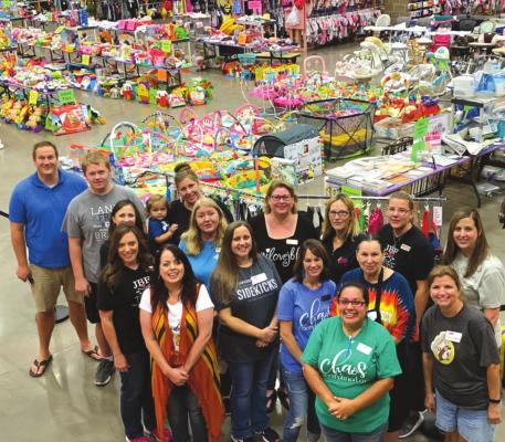 Carrie Bloom in the middle surrounded by her dedicated group of helpers at a previous Just Between Friends sale. Courtesy photo