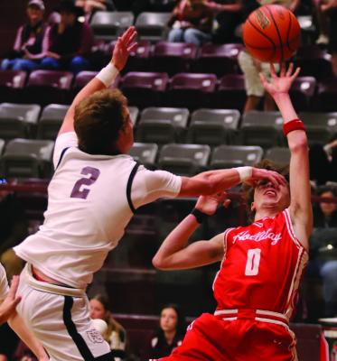 Holliday guard Jason Luke draws the foul and makes a blind layup against Bowie’s Rayder Mann on Friday, Jan. 9. Photo/Landon Davis