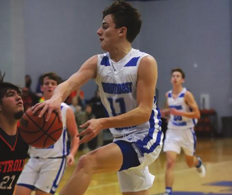 Windthorst’s Logan Cope dishes out a pass in the Trojans’ 57-55 loss to Petrolia on Tuesday, Jan. 18. Photo/Will Edwards