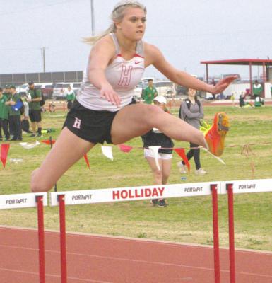 Holliday’s Grayson Castagna clears the final hurdle before racing to the finish in the girls 100 hurdles. Castagna finished first with a time of 18.36. Photo/Ravyn Fager