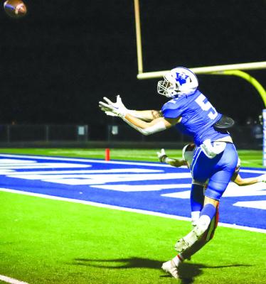 Windthorst’s Brayden Berend fights back for the football before scoring on a 25-yard pitch-and-catch from Logan Cope in the third quarter of the Trojans’ 30-18 win over Petrolia on Friday, Oct. 7. Photo/Will Edwards