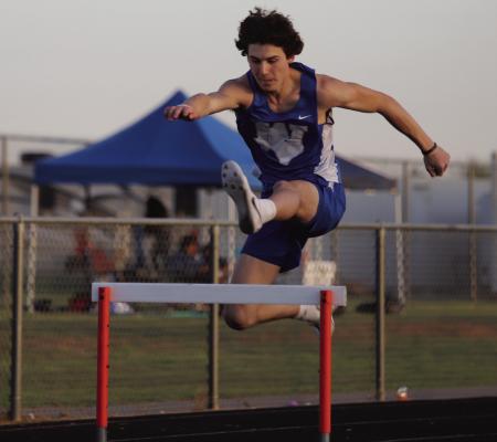 Windthorst’s Daxton Anderson skims over the hurdle at the district meet in Petrolia. Anderson took home golds in both the 110 and the 300 hurdles. Photo/Landon Davis