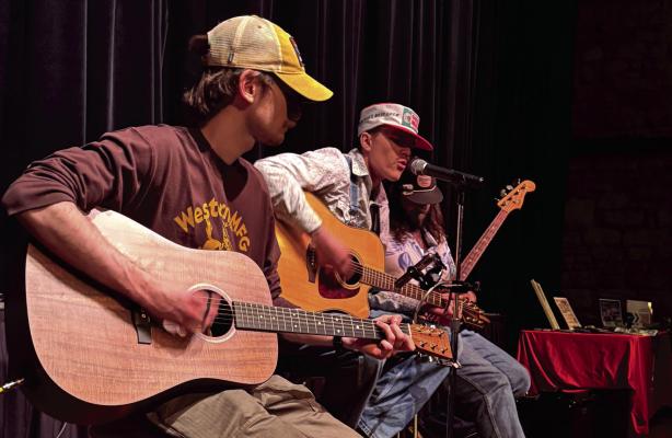 Archer City native Eli Anderson sings lead vocals in the band Young Road Recalls, which also includes Zach Molina and Sam Franklin. The three young regional musicians opened for Tony Kamel and the Felons at the May 10 Unearthing Archer County event at the Royal Theater. Photo/Jenny Schroeder