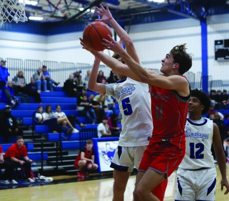 Holliday guard Ty Harrison drives the lane and converts a contest layup against the City View Mustangs on Friday, Feb. 7. Harrison finished the night with 15 points. Photo/Landon Davis