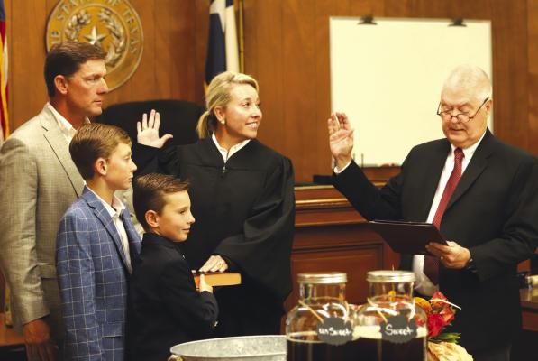 New 97th District Judge Trish Coleman Byars is surronded by her family as she takes the oath of office given by former 97th District Judge Jack A. McGaughey in the Clay County Courthouse on Friday, July 28. File photo