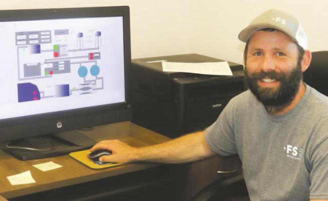John Fluharty of FS Specialist shows off the monitoring to the Archer City water plant. File photo