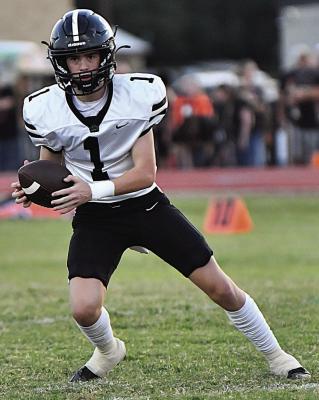 Wildcat quarterback Parker Hilbers rolls to his right in Archer City’s loss to Nocona on Friday, Sept. 19. Courteys photo/Donna Williams
