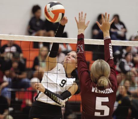 Lady Cat hitter Brilee Canada slams a kill by a pair of Vernon Lady Lions during the Cool in Boomtown Volleyball Tournament in Burkburnett on Friday, Aug. 15. Photo/Landon Davis