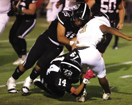 Twin brothers Seth (15) and Reed (14) Truette tackle a Haskell ballcarrier in the Wildcat’s home district game against the Indians on Friday, Oct. 17. Photo/Landon Davis