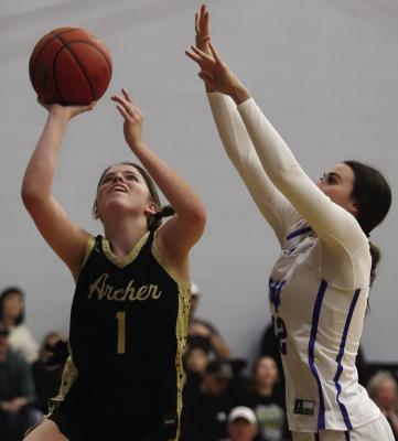 Archer City junior Jocelyn Tedrow drives by Windthorst senior Kyah Frank for a score in their clash on Tuesday, Jan. 13. Photo/Landon Davis
