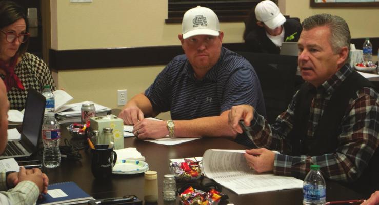 Cameron Gulley (right) presents a clean audit report to the Archer City ISD school board as board members Zach Rowe (middle) and Jeannie Hilbers (left) listen on Dec. 16. Photo/Nathan Lawson