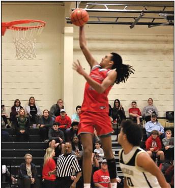 Holliday Eagle Keitenn Bristow goes airborne for a dunk in the third period for 2 of his 21 points. Photo/Jerry Phillips