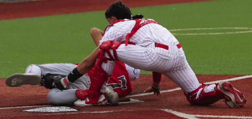 Holliday catcher Kason Poston makes the tag at home plate following a laser of a throw from Steele Skinner during a game one win over Sweetwater. Photo/Nathan Lawson
