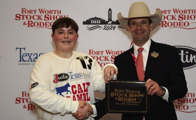 Brantley Humpert (left) is awarded a Calf Scramble purchase certificate at the 2024 FWSSR by Calf Scramble Committee Member Paxton Motheral (right). Courtesy photo
