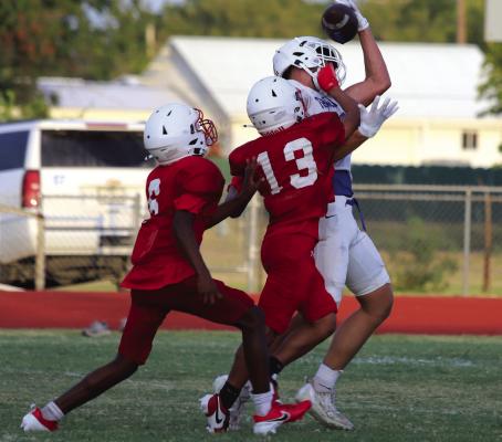 Windthorst wideout Jaxon Stark makes a contested grab over two Olney defenders in the Trojan’s scrimmage against the Cubs on Thursday, Aug. 15. Photo/Landon Davis