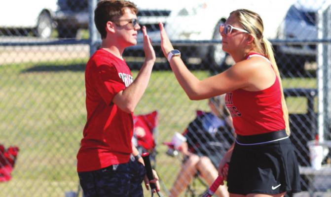 Holliday’s Braden Childs and Lybi Carlton celebrate a point at the District Tennis Tournament on Monday, March 28, in Bowie. Photo/Will Edwards